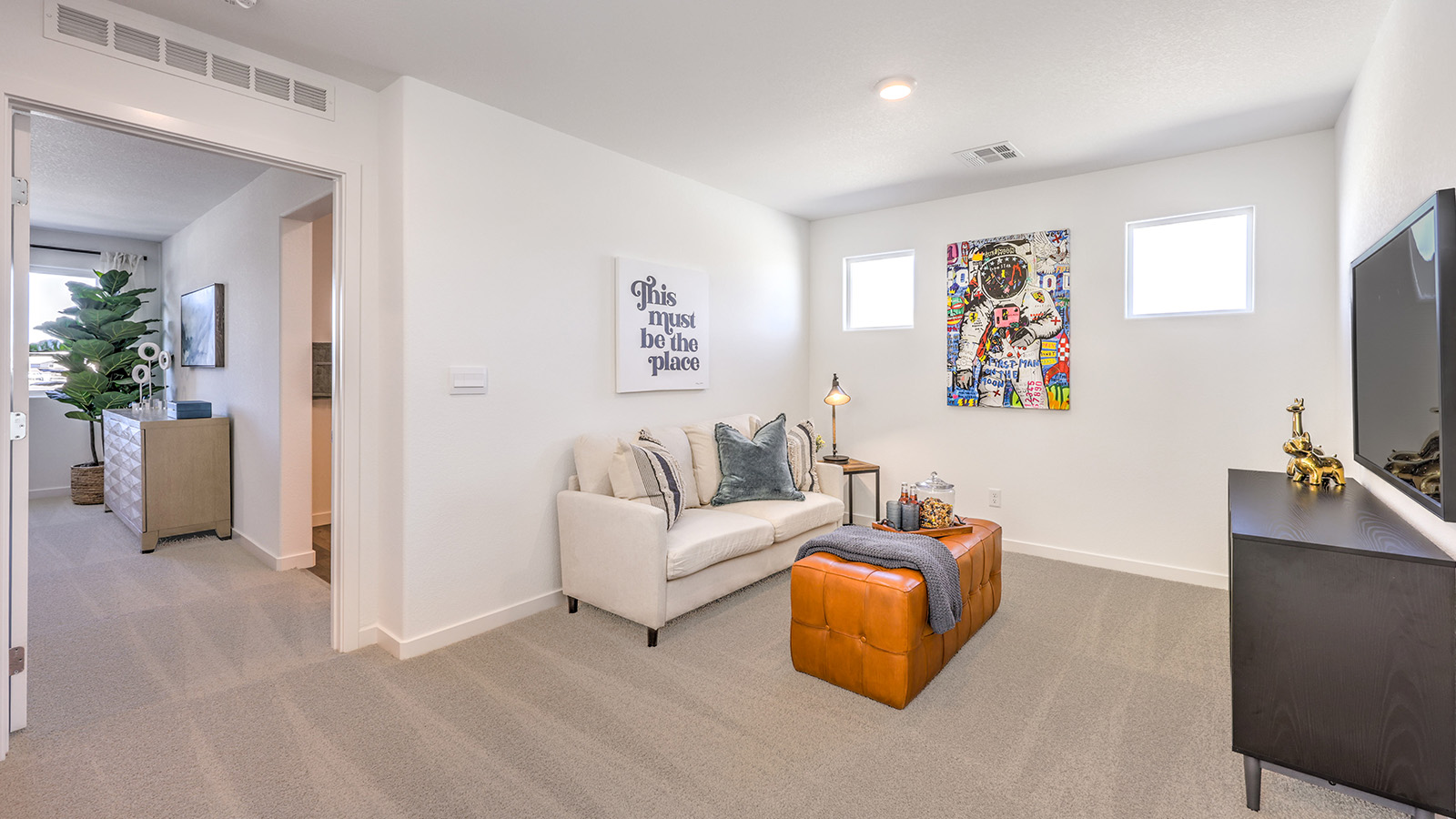 At the top of the stairs, the loft in our Heartland Bay 1872 plan with carpet flooring.
