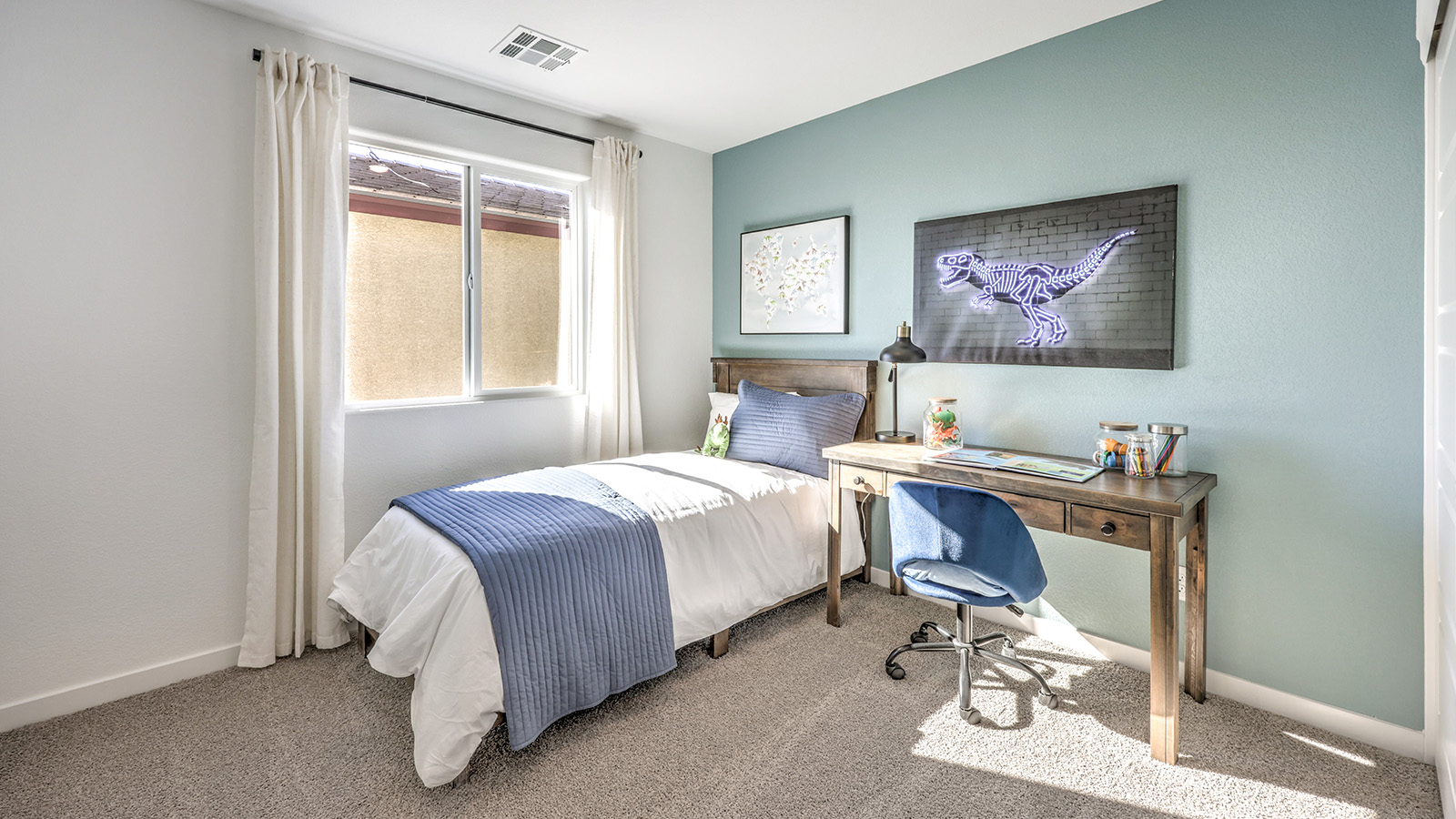 Bedroom Two in our Heartland Bay 1872 model with carpet flooring, a sliding closet, and one window.