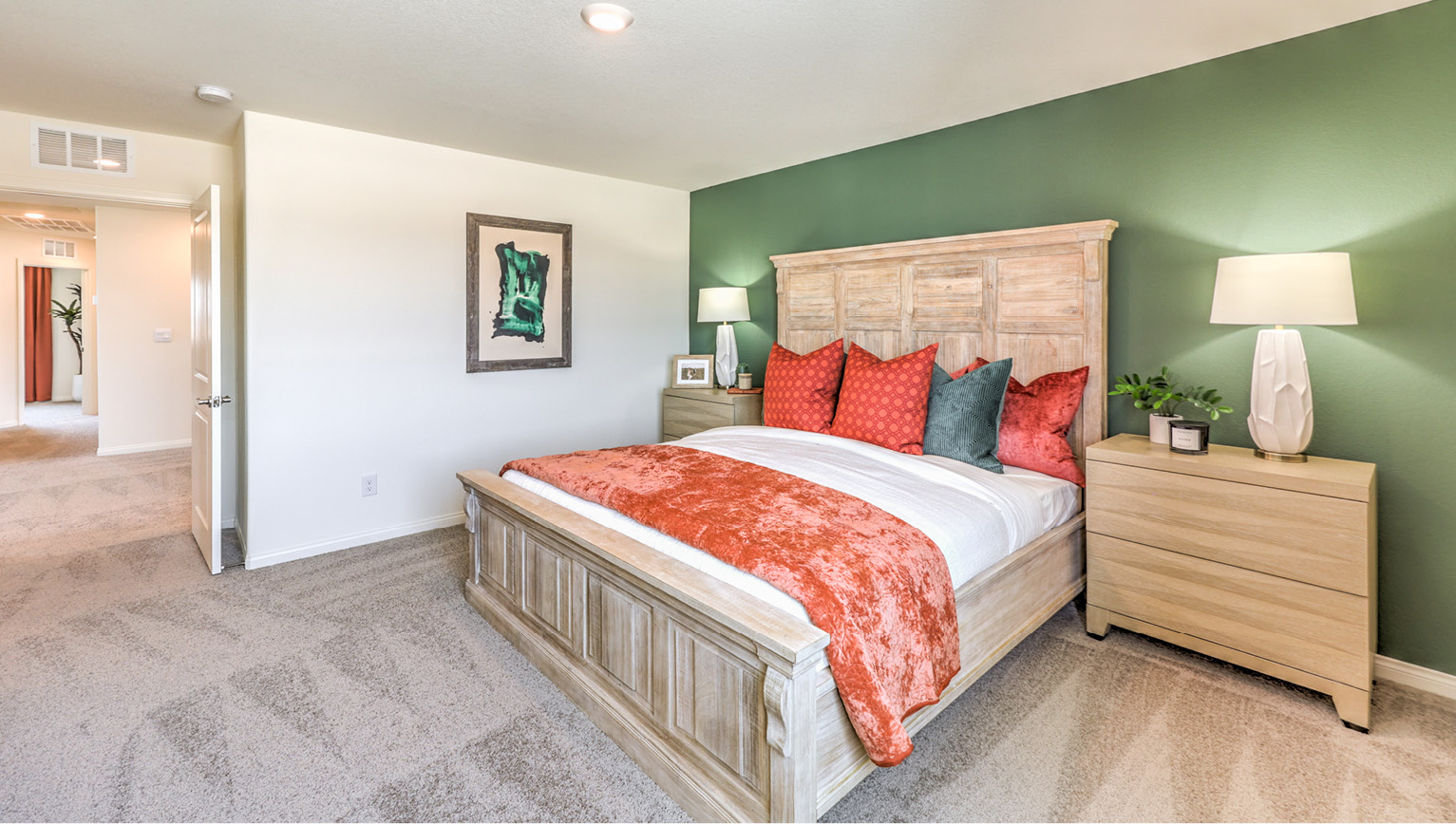 The Bedroom One Suite in our Heartland Bay 1865 model with carpet flooring, recessed ceiling lights, and a walk-in closet.