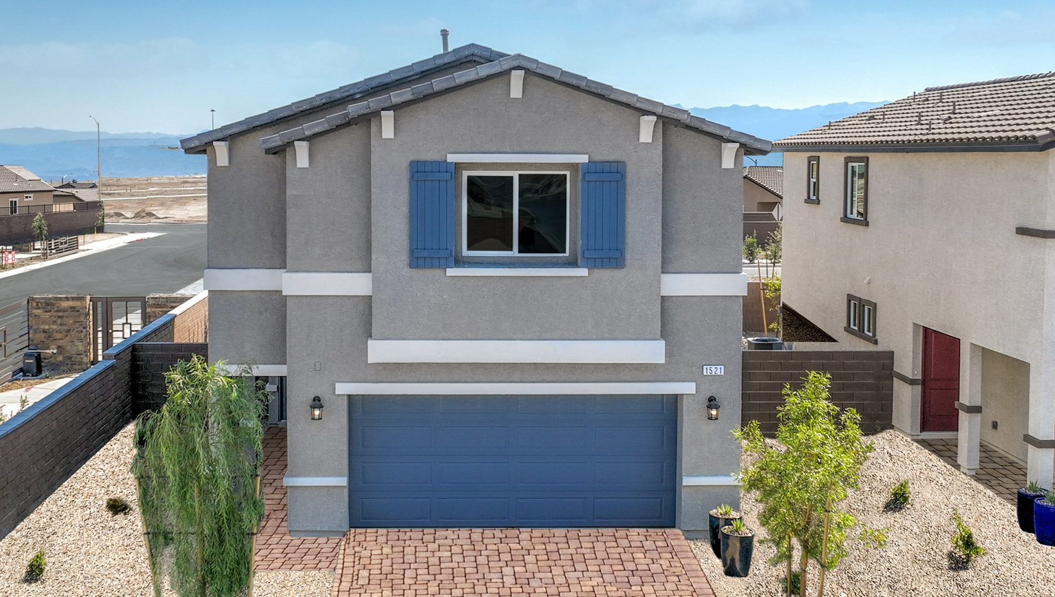 Exteriors in our Heartland Bay Community featuring front yard landscaping, paver driveways, and two-car garages.