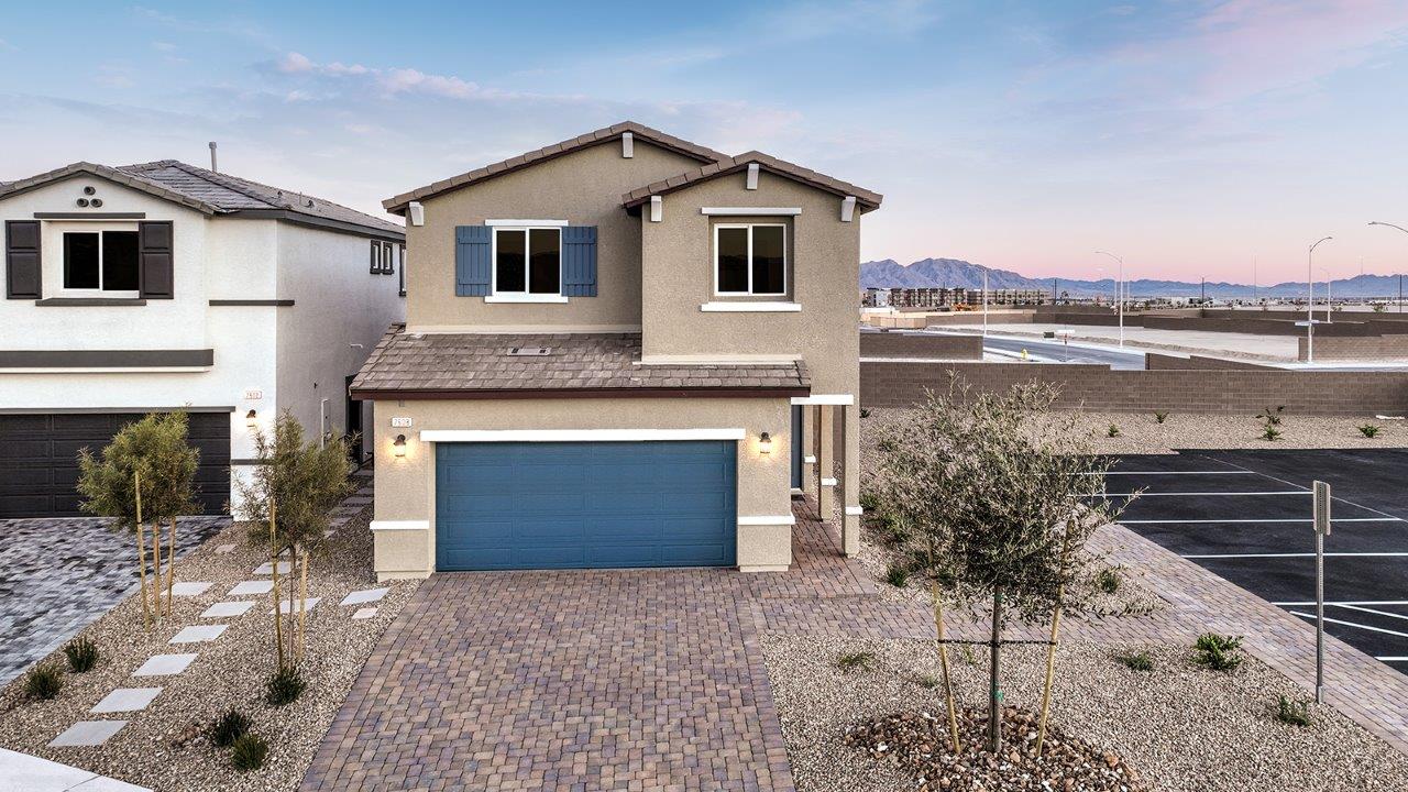 Exteriors in our Heartland Bay Community featuring front yard landscaping, paver driveways, and two-car garages.