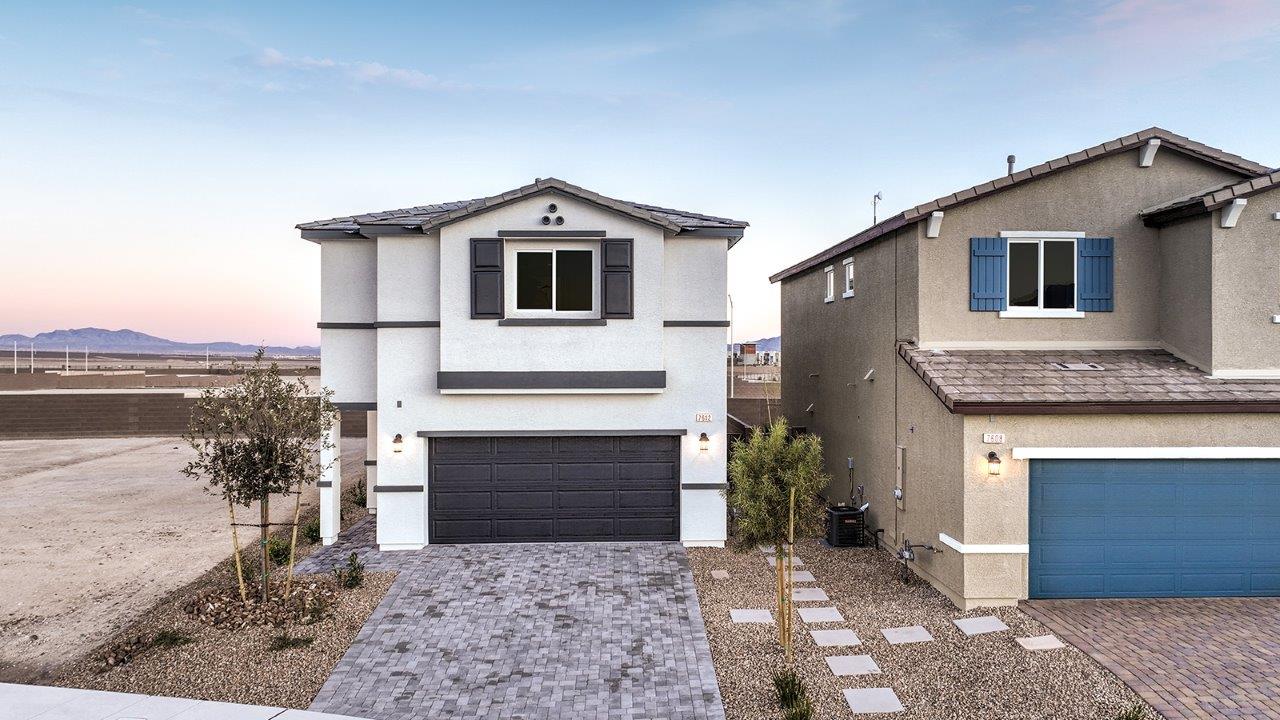 Exteriors in our Heartland Bay Community featuring front yard landscaping, paver driveways, and two-car garages.