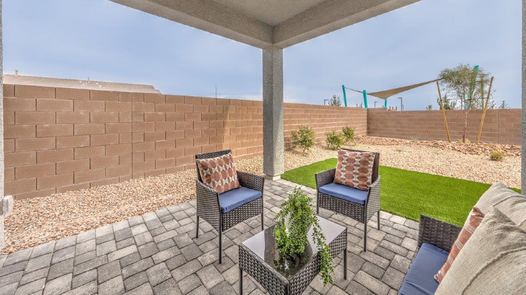 Our Heartland Grove 1839 model backyard with desert landscaping and a seating area.