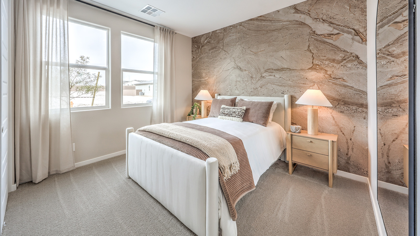 Bedroom Three in our Heartland Grove 1839 model with carpet flooring, a sliding closet, and a window.