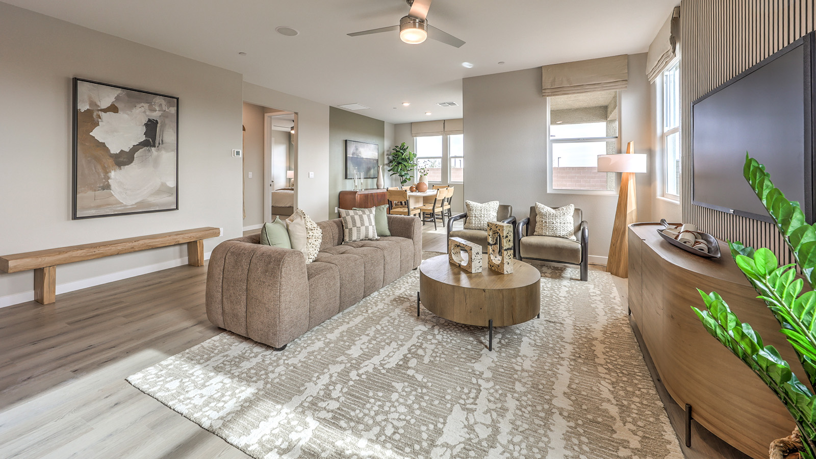 The Heartland Grove 2048 Plan open concept Great Room with LVP panel flooring and a large window.