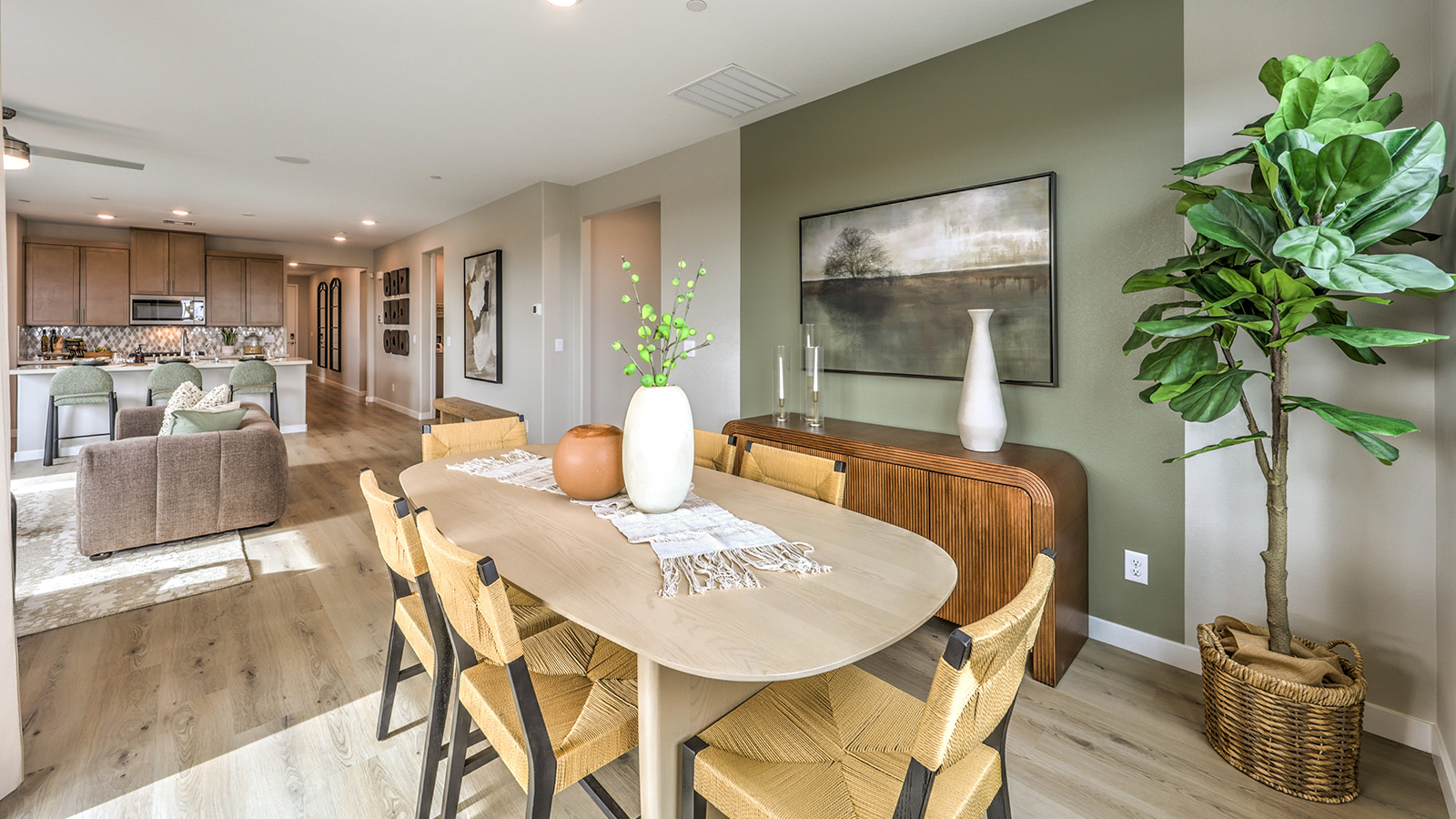 The Heartland Grove 2048 model Dining Room adjacent to the kitchen with a table and two windows.