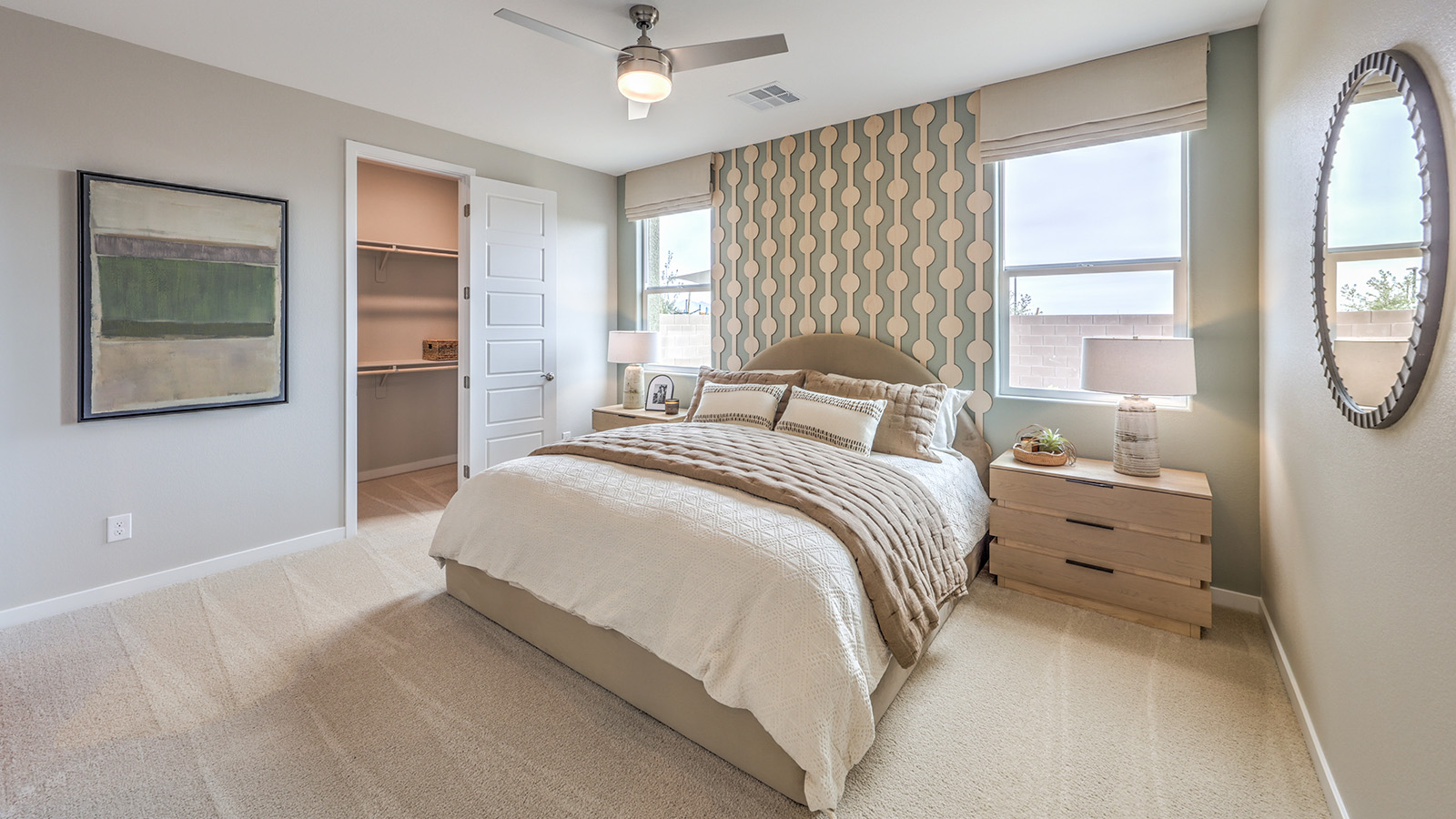 The Bedroom One Suite in our Heartland Grove 1839 model with carpet flooring, large windows, and recessed ceiling lights.