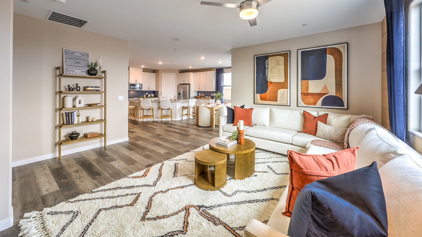 The Heartland Grove 1839 Plan open concept Great Room with LVP panel flooring and a large window.