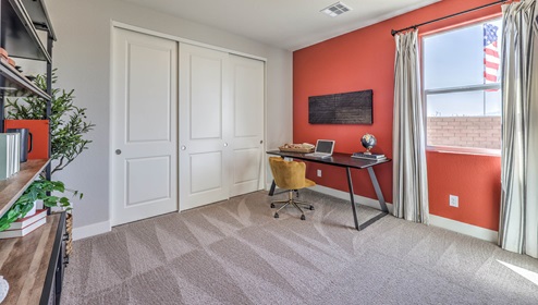The third bedroom in our Heartland Manor 2754 Plan features plush carpet flooring, a spacious layout, and a large window for natural light. With a standard closet and ample space, this versatile room can be used as a bedroom or a home office to fit your needs.
