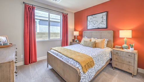 The MultiGEN bedroom in our Heartland Manor 2754 Plan features plush carpet flooring, a spacious layout, and a large window that fills the room with natural light. Designed for comfort and privacy, this bedroom is part of the MultiGEN suite, offering a flexible living space for multi-generational households.