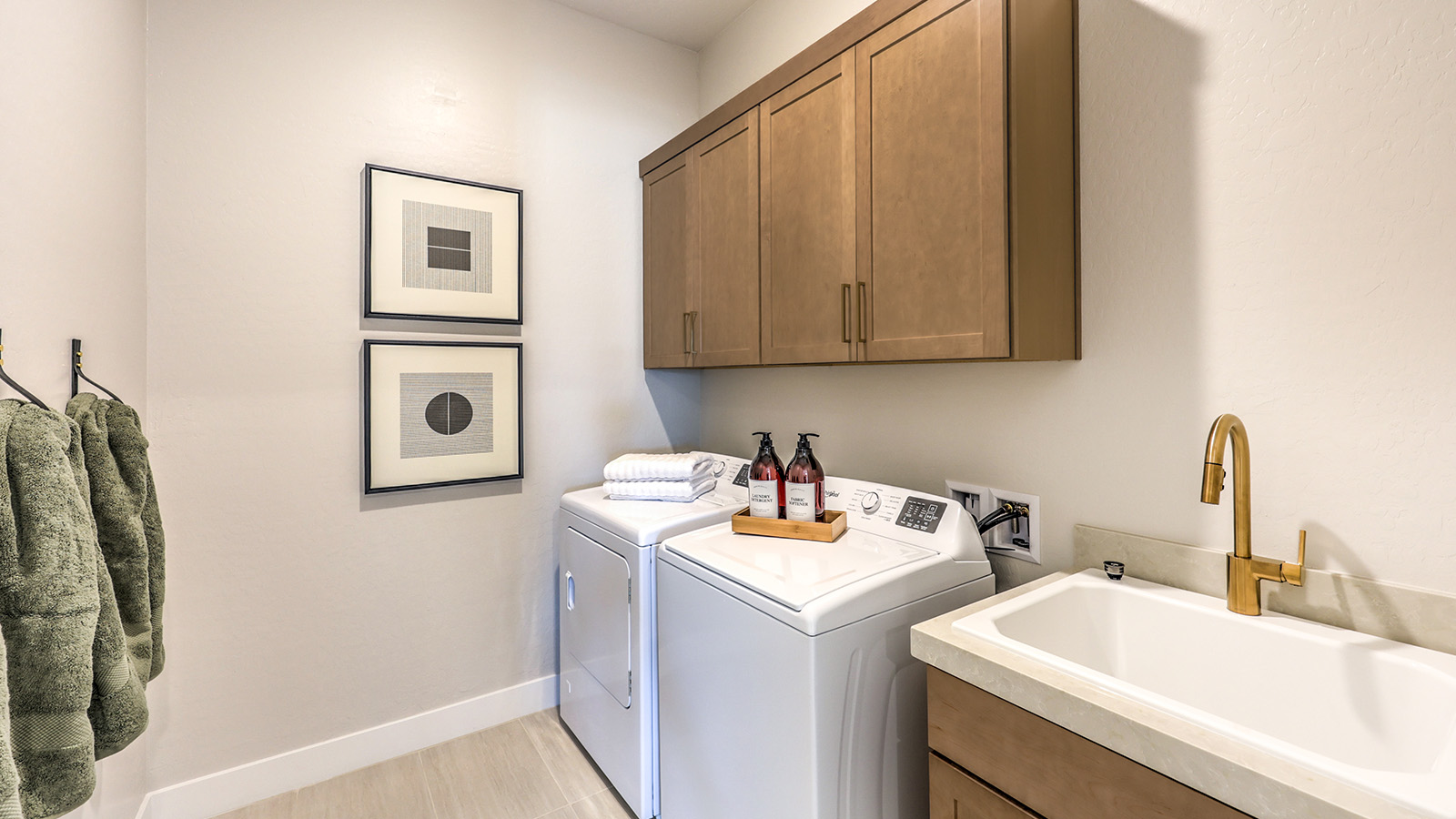 Our Heartland Manor 2754 model laundry room with a shelf and a washer and dryer.