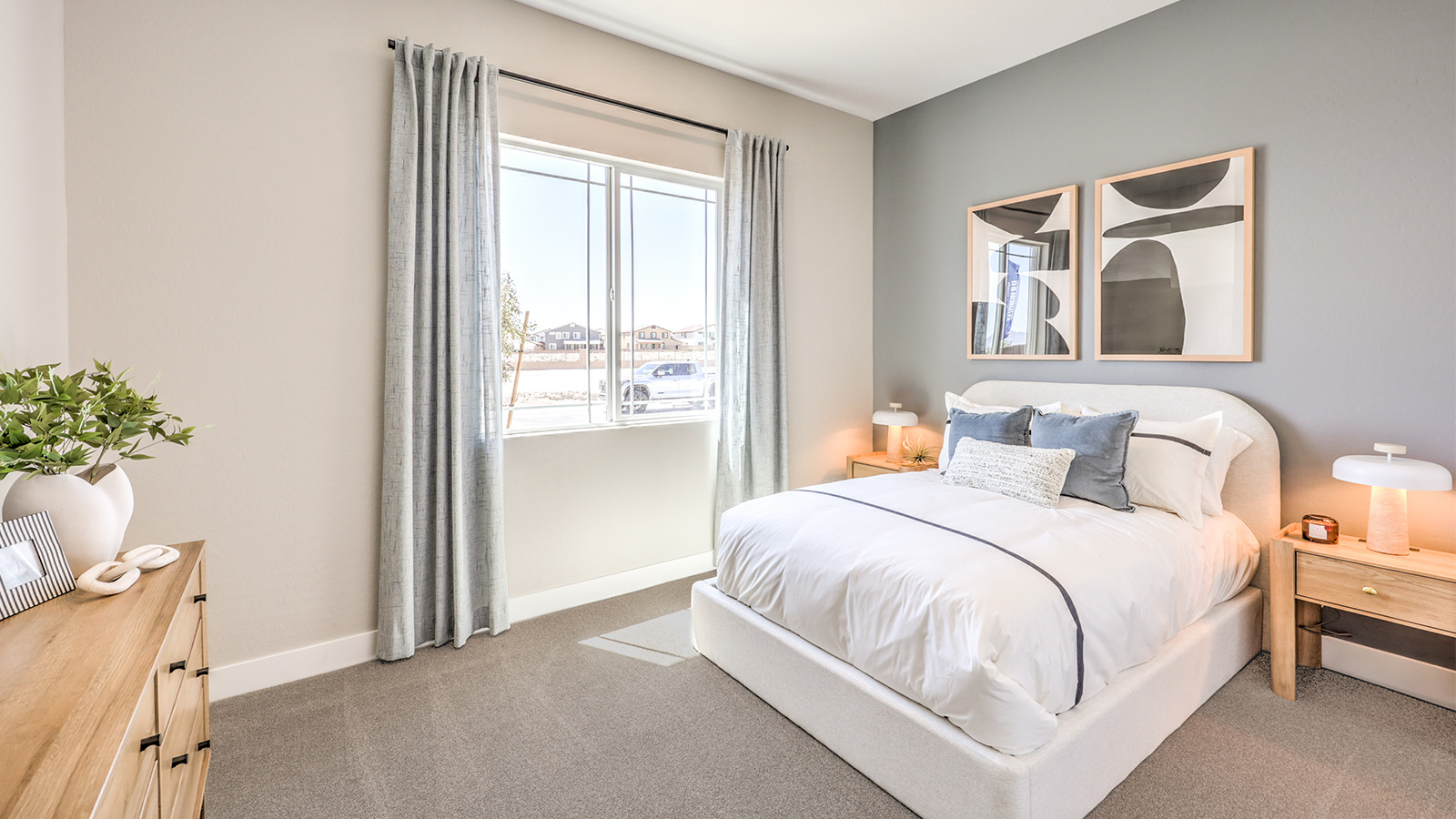 The fourth bedroom in our Heartland Manor 2538 Plan features plush carpet flooring, a spacious layout, and a large window that fills the room with natural light. Designed for comfort and privacy, this bedroom is part of the MultiGEN suite, offering a flexible living space for multi-generational households.