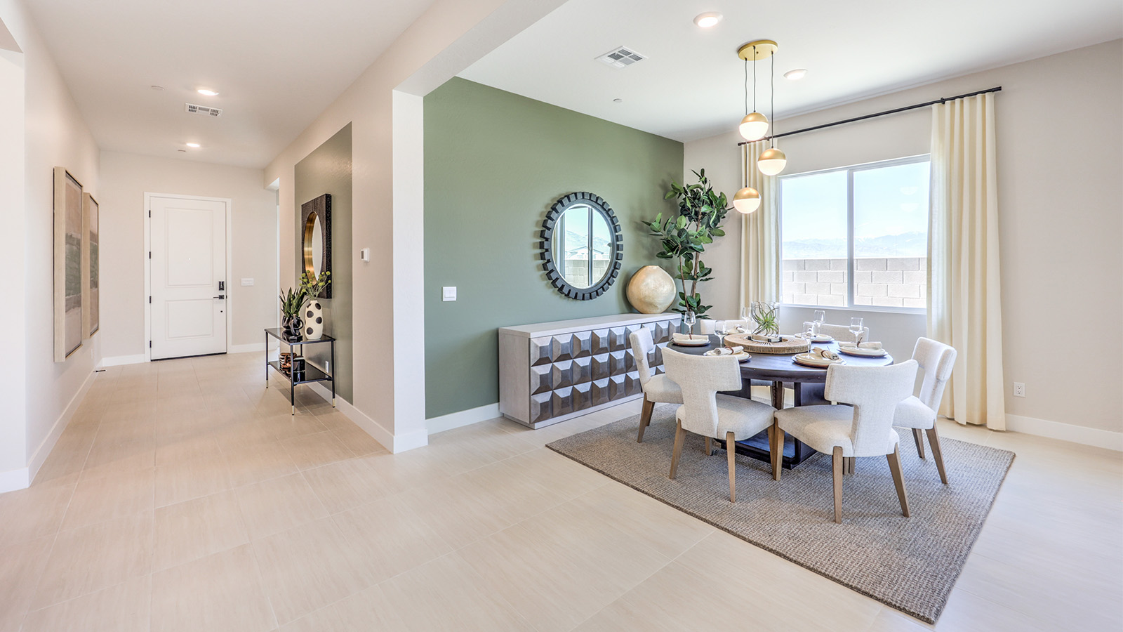 The dining room and great room in our Heartlnad Manor 2754 Plan features an open-concept design with 9-foot flat ceilings and luxury vinyl plank flooring. The dining area is spacious, with a large window allowing natural light to fill the space. Adjacent to it, the great room offers a bright and airy feel, enhanced by additional windows and sliding glass doors leading to the backyard. The seamless flow between these areas creates a welcoming and functional living space.