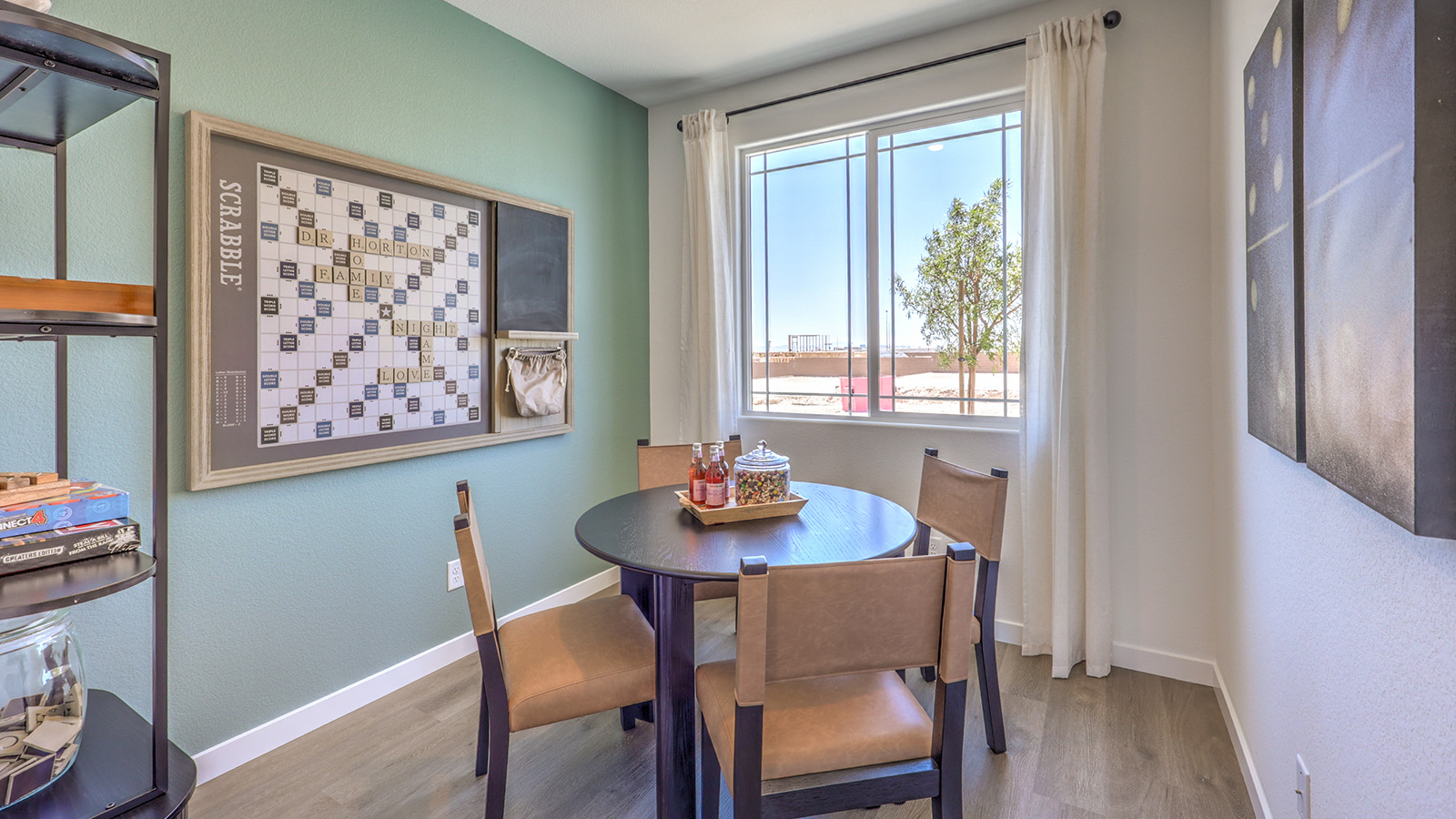 The Heartland Cottages 1865 model Dining Room adjacent to the kitchen with a table and window.
