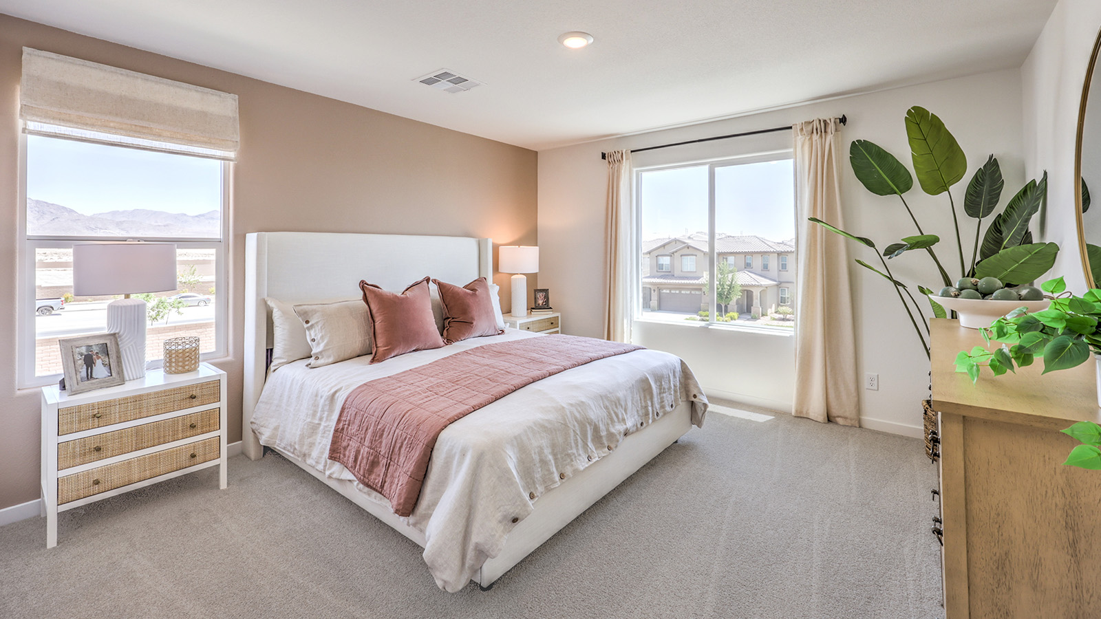The Bedroom One Suite in our Heartland Cottages 1700 model with carpet flooring, walk-in closet, and a ceiling fan with a light kit.