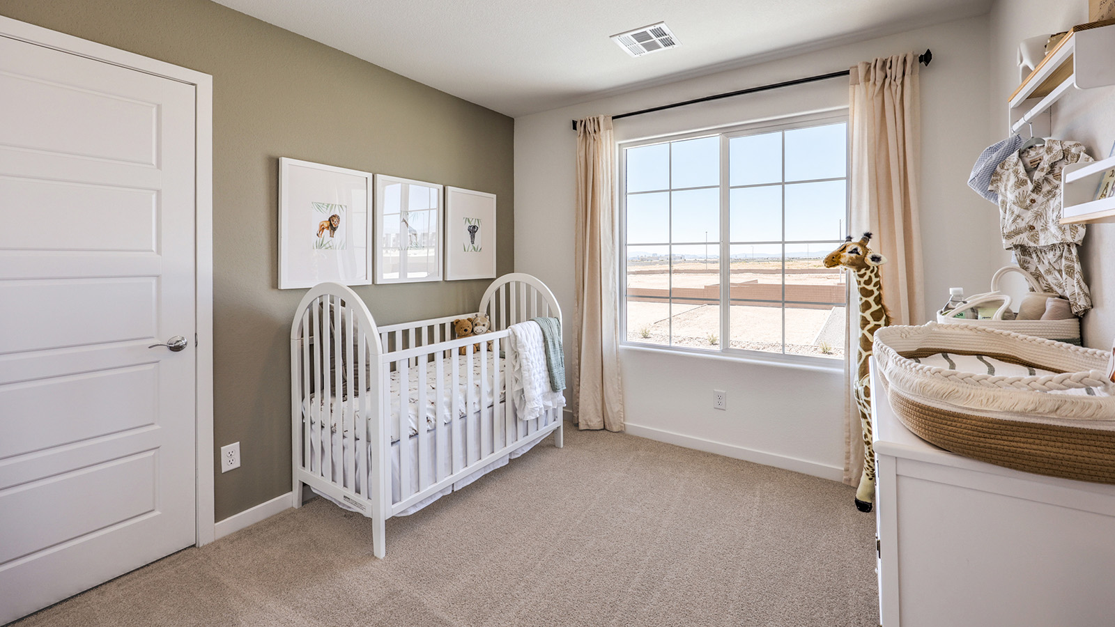 Bedroom Two in our Heartland Cottage 1700 model with carpet flooring, a sliding closet, and one window.