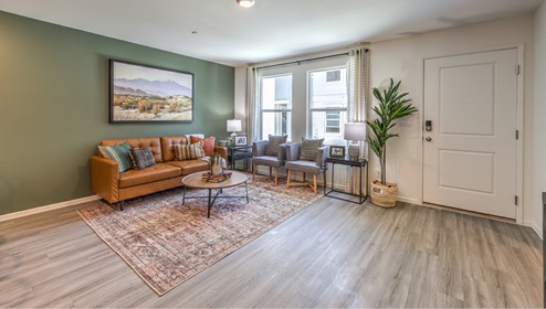 The Canyon Trails 1309 Plan open concept Great Room with LVP panel flooring and two windows.