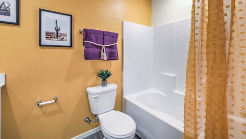 Bathroom Two in our Canyon Trails 1309 model with quartz/marble fusion countertops at the Bath Vanity, a walk-in shower, mirror, and white cabinets.