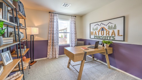 The Office/Bedroom Three option in our Canyon Trails 1309 model with carpet flooring and a sliding closet, furnished with a desk and chair.