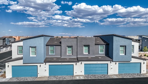 Canyon Trails community with a paver driveway and walkway, a 2-car garage, and lighted address numbers.