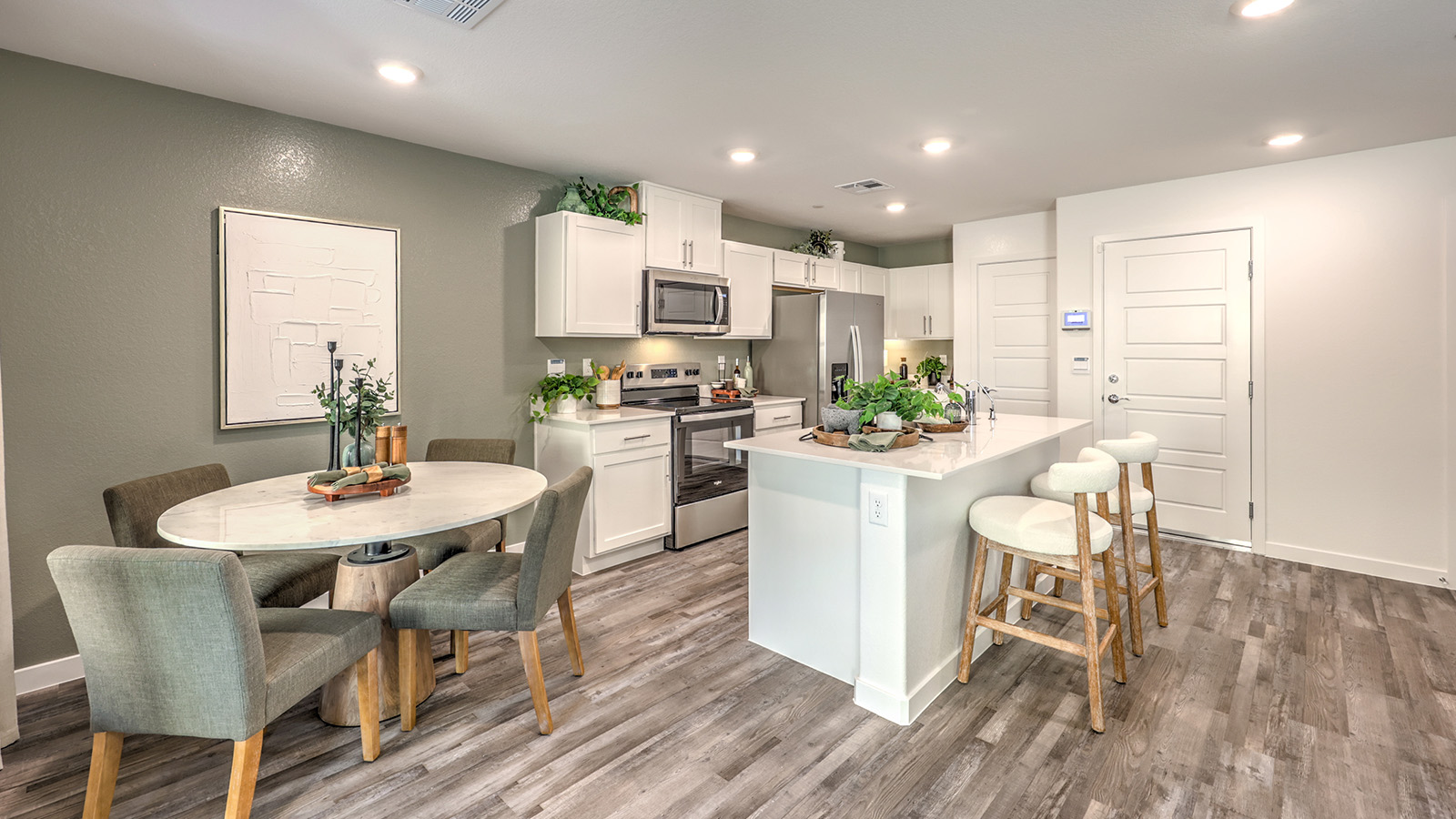 The Canyon Trails 1410 model Dining Room adjacent to the kitchen with a table and window.