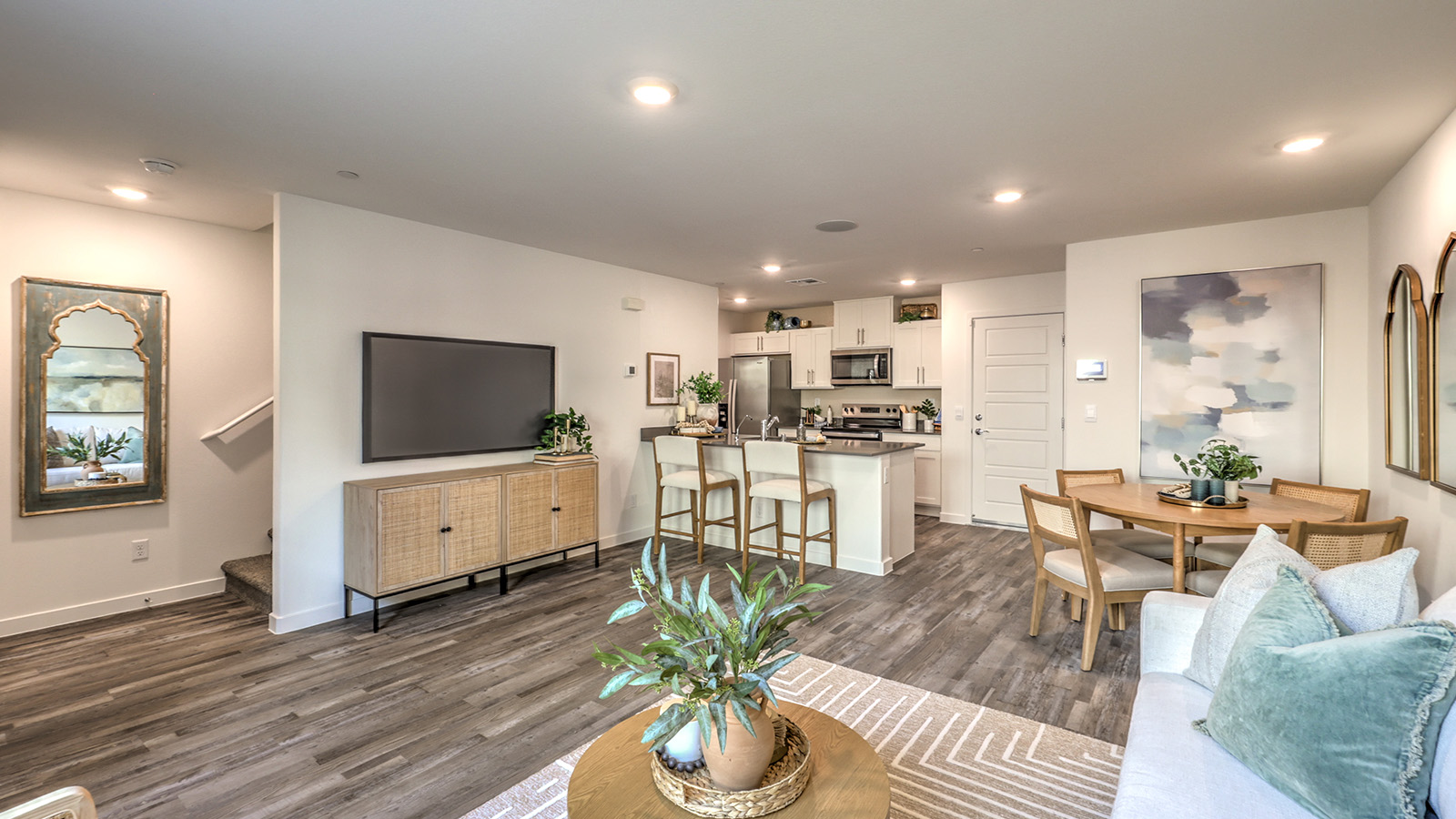 The Canyon Trails  1309 Plan open concept Great Room with LVP panel flooring and a view of the kitchen.