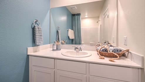 On the second floor this home has a second full size bathroom with a single sink and storage space underneath the sink, a shower and toilet.
