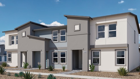 Our 1309 model home in the Kalea Trails community with grey and white exterior paint schemes, common area landscaping, and paved walkways.