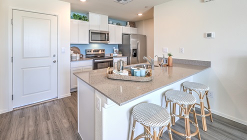 This townhome has a spacious kitchen with a center island that has spacious counters.