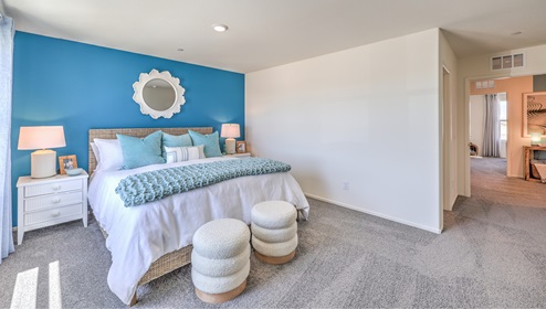 Our second floor is where you will find the spacious main bedroom. This specific model has a king size bed with a night stand on both sides with plenty of space for a dresser and entertainment center. This main bedroom also has large windows to bring in some natural light