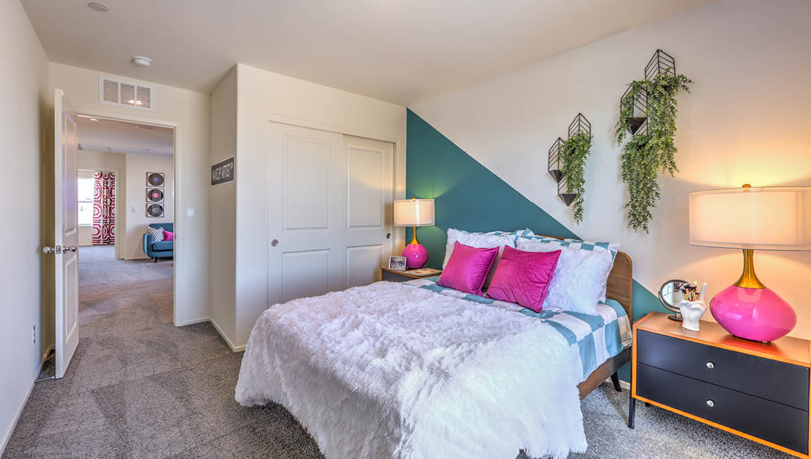 Bedroom Three in our Kalea Trails 1430 model with carpet flooring and a sliding closet.