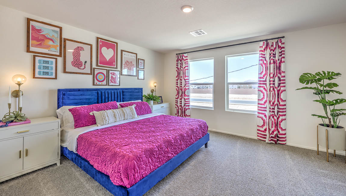 The Bedroom One Suite in our Kalea Trails 1430 model with carpet flooring, two windows, and recessed ceiling lights.