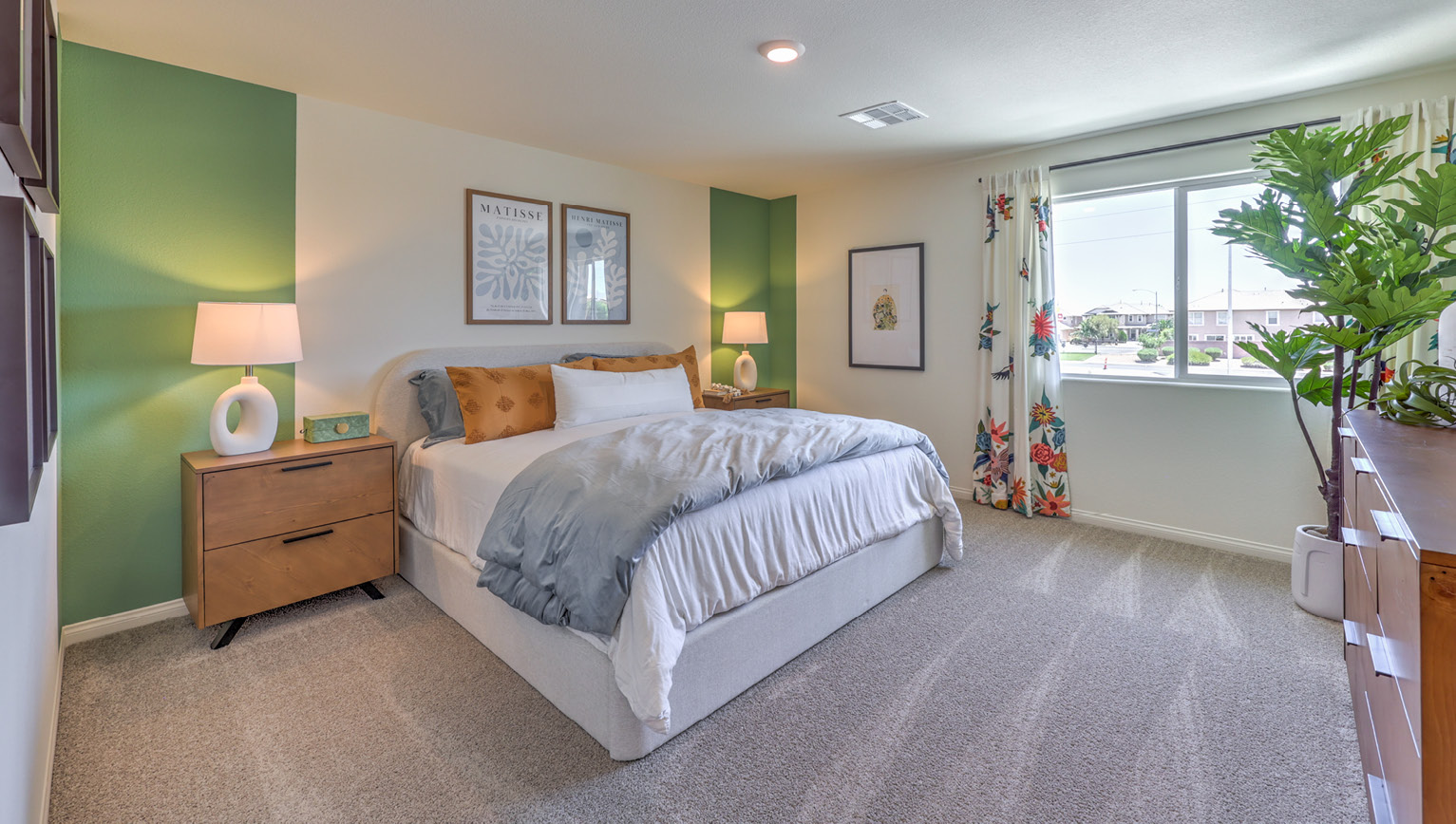 The Bedroom One Suite in our Kalea Bay 1865 model with carpet flooring, recessed ceiling lights, walk-in closet, and a large window.