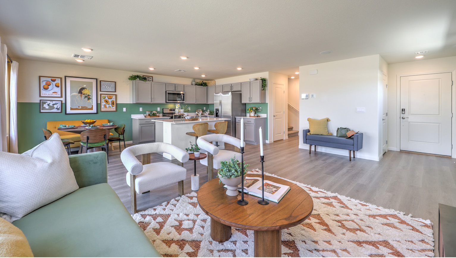 The Kalea Bay 1865 Plan open concept Great Room with LVP panel flooring and a view of the kitchen.