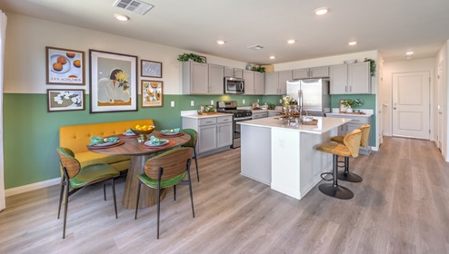 Kitchen with center island, refrigerator and stainless steel appliances that include microwave, stove, dishwasher and refrigerator