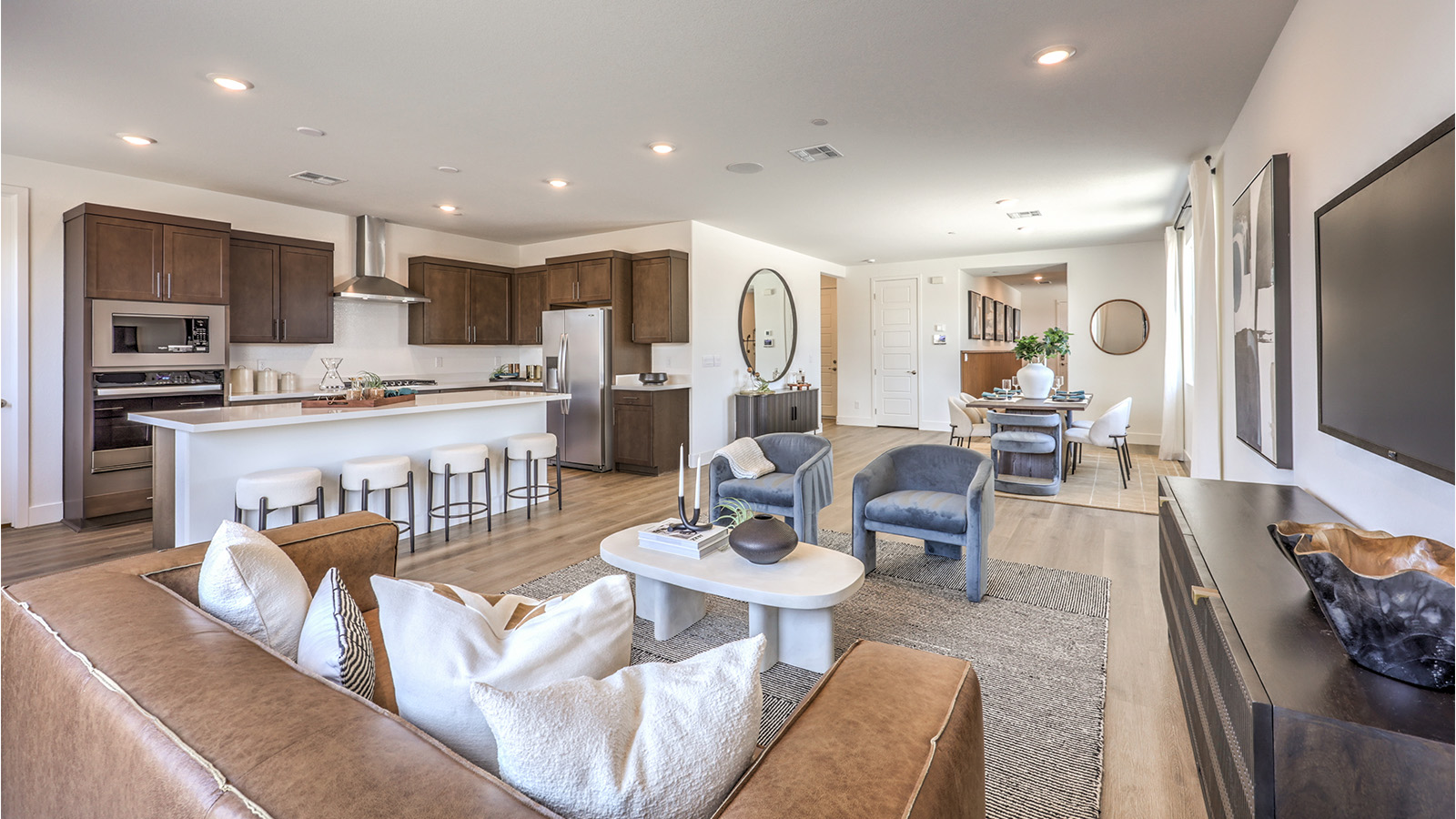 The Heartland Falls 3000 Plan open concept Great Room with ceramic tile flooring, large windows, and a sliding door to the backyard.
