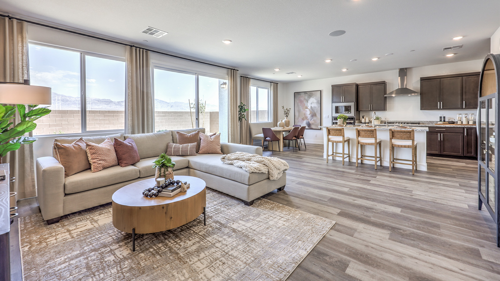 The Heartland Falls 2660 Plan open concept Great Room with ceramic tile flooring, large windows, and a sliding door to the backyard.