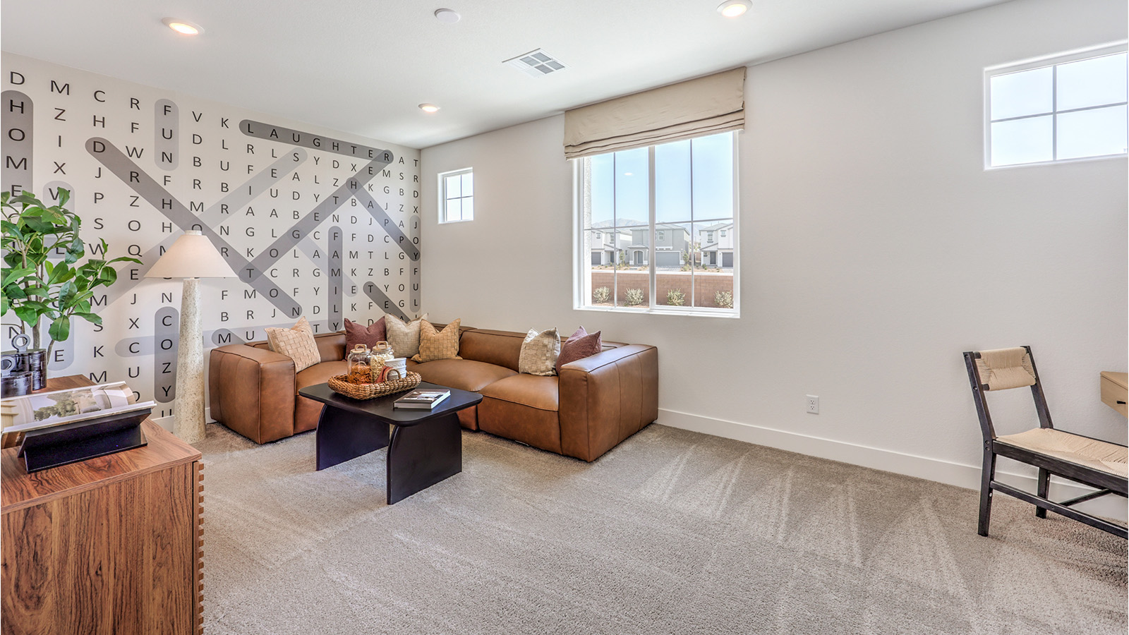 The upstairs loft in our 2600 model with carpet flooring and large windows.