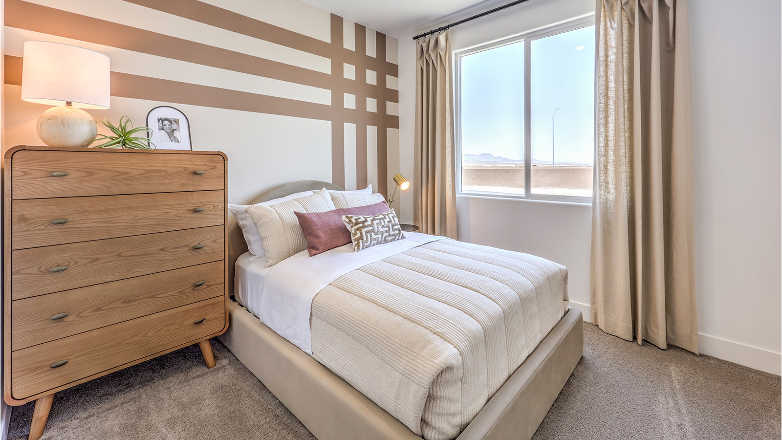 The Bonus Room in our Heartland Falls 2660 plan with carpet flooring and windows.