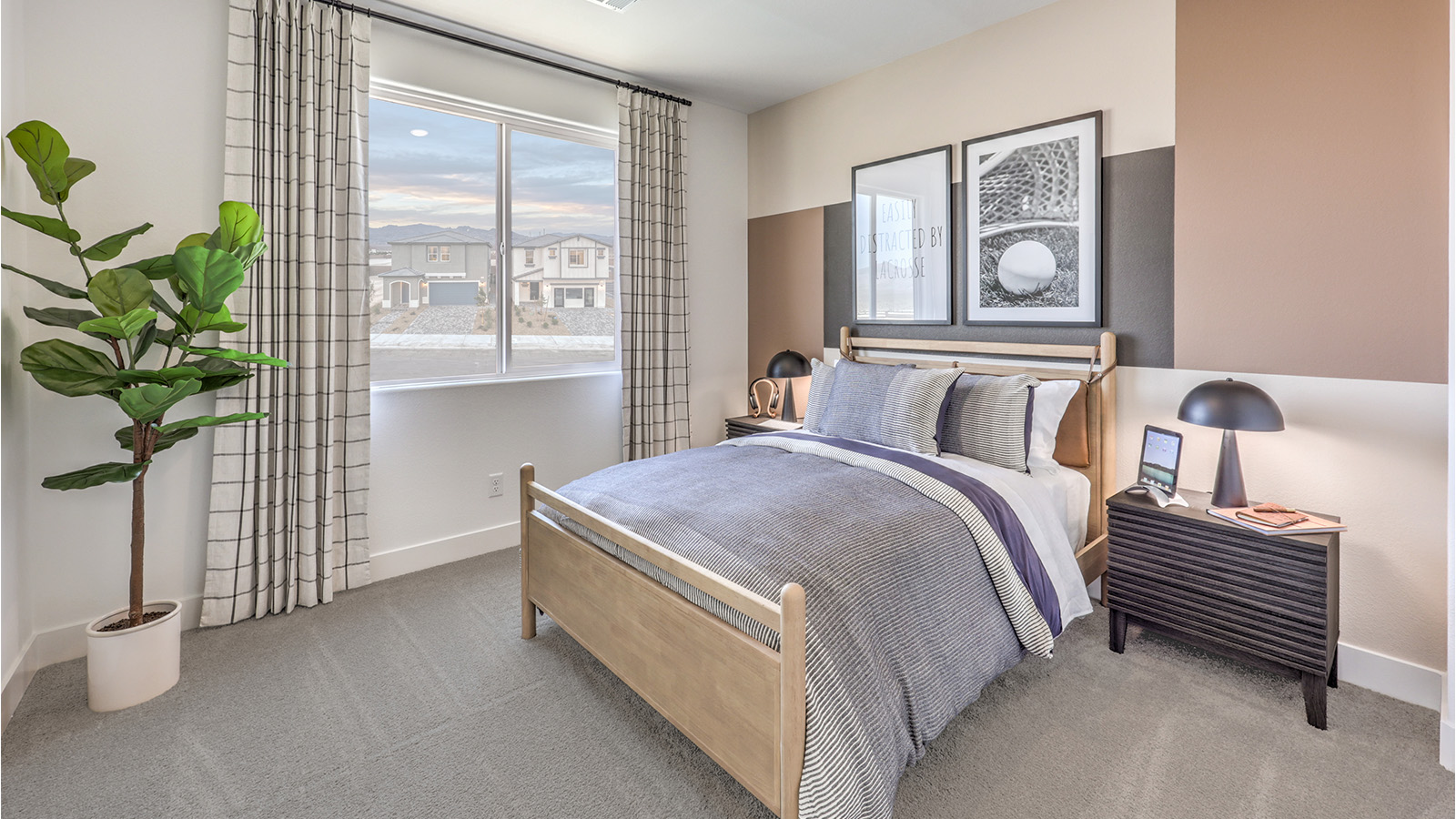 Bedroom Three in our Heartland Falls 2660 model with carpet flooring, a sliding closet, and a window.