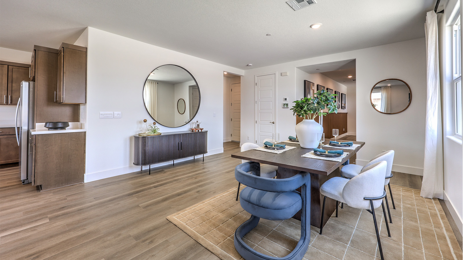 The Heartland Falls 3000 model Dining Room adjacent to the kitchen with a table and window.