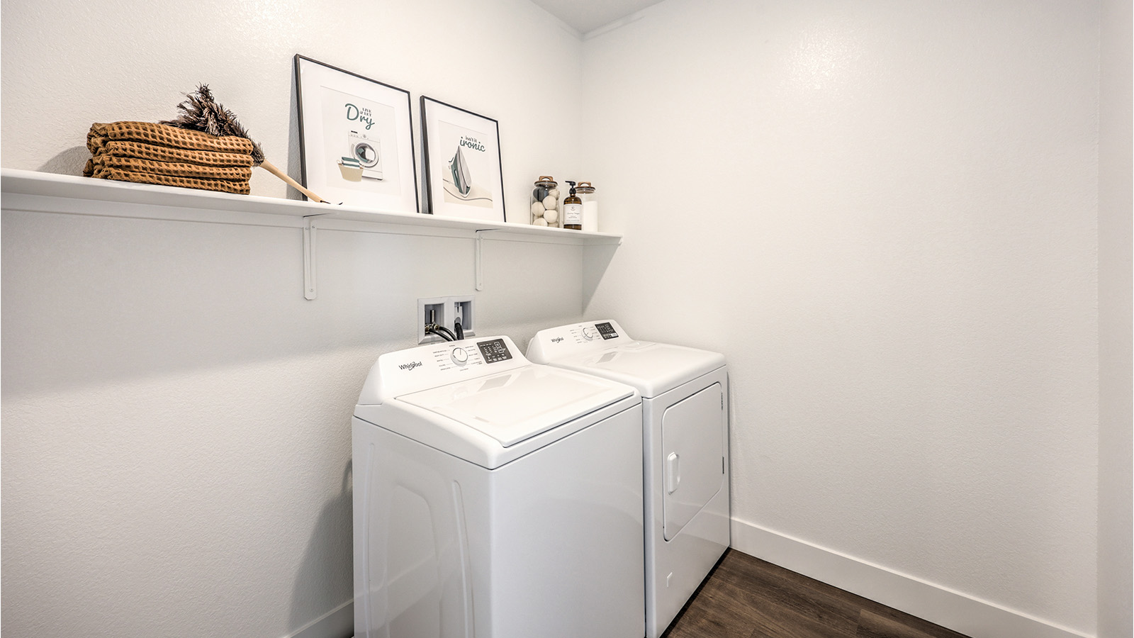 Our Heartland Falls 2988 model laundry room with a shelf and a washer and dryer.