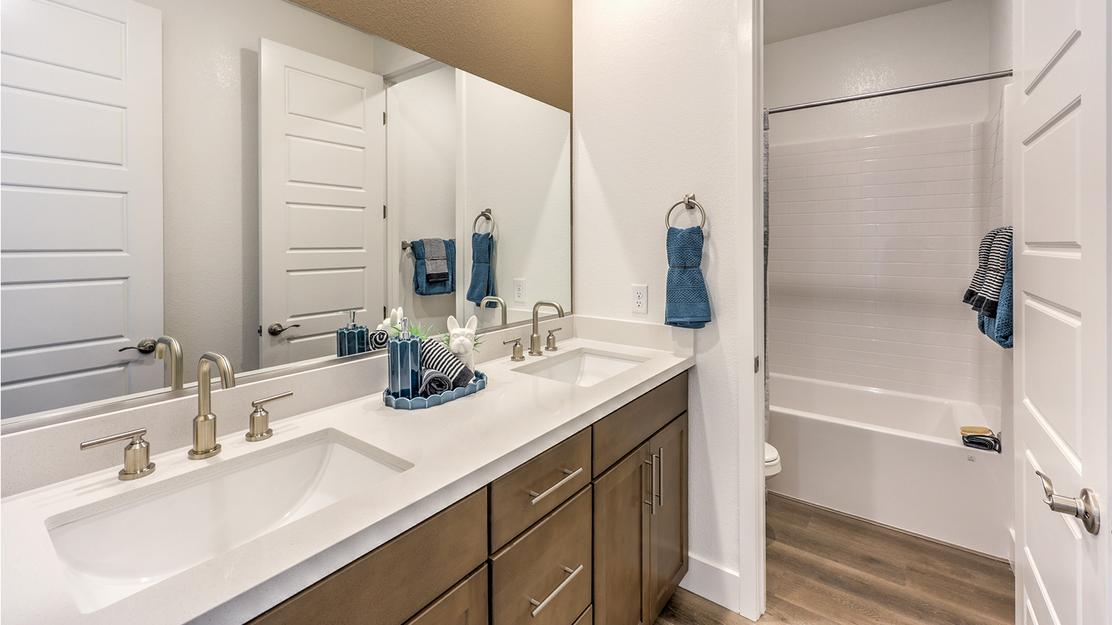 Bathroom Two in our Heartland Falls 3000  model with Granite countertops at the Bath Vanity, a walk-in shower, mirror, and white cabinets.