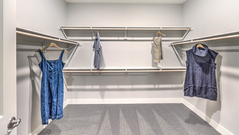Attached to the Bedroom One Suite, our 3001 model bathroom with granite countertops at the double Bath Vanity, a walk-in shower, walk-in closet, linen closet, mirror, and white cabinets.