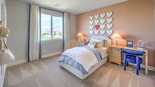 Bedroom Three in our Heartland Falls 3001 model with carpet flooring, a sliding closet, and a window.