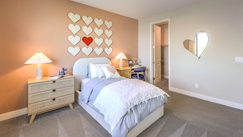 Bedroom Three in our Heartland Falls 3001 model with carpet flooring, a sliding closet, and a window.