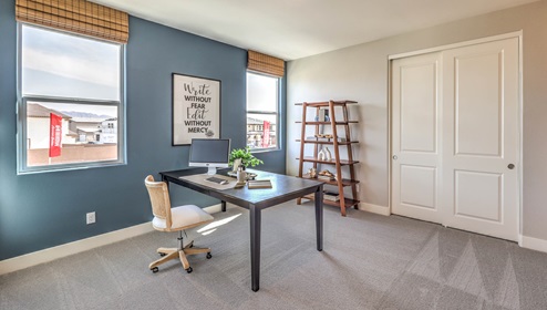 The fourth bedroom in our Heartland Falls 3001 Plan features plush carpet flooring, a spacious layout, and a large window for natural light. With a standard closet and ample space, this versatile room can be used as a bedroom or a home office to fit your needs.