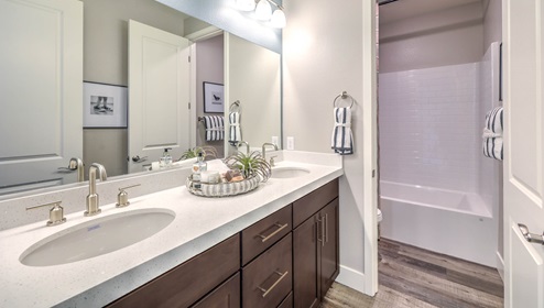 Bathroom Two in our Heartland Falls 3001 model with Granite countertops at the Bath Vanity, a walk-in shower, mirror, and white cabinets.
