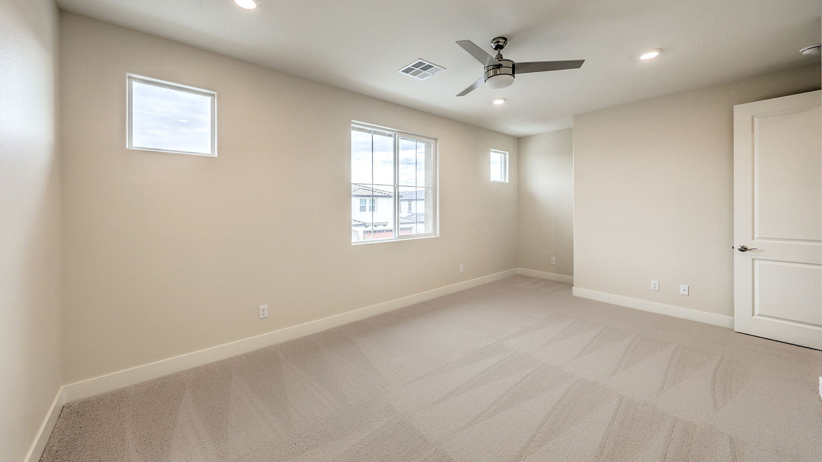 Bedroom Two in our Heartland Falls 2660 model with carpet flooring, a sliding closet, and a window.