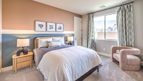 Bedroom Five in our Heartland Falls 3001 model with carpet flooring, a walk in closet, and a window.